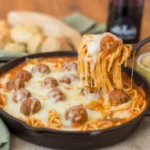 Cheesy Baked Spaghetti & Meatballs casserole fresh from the oven, gooey and delicious.