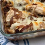 French Onion Chicken Bake with caramelized onions and melted cheese in a baking dish.