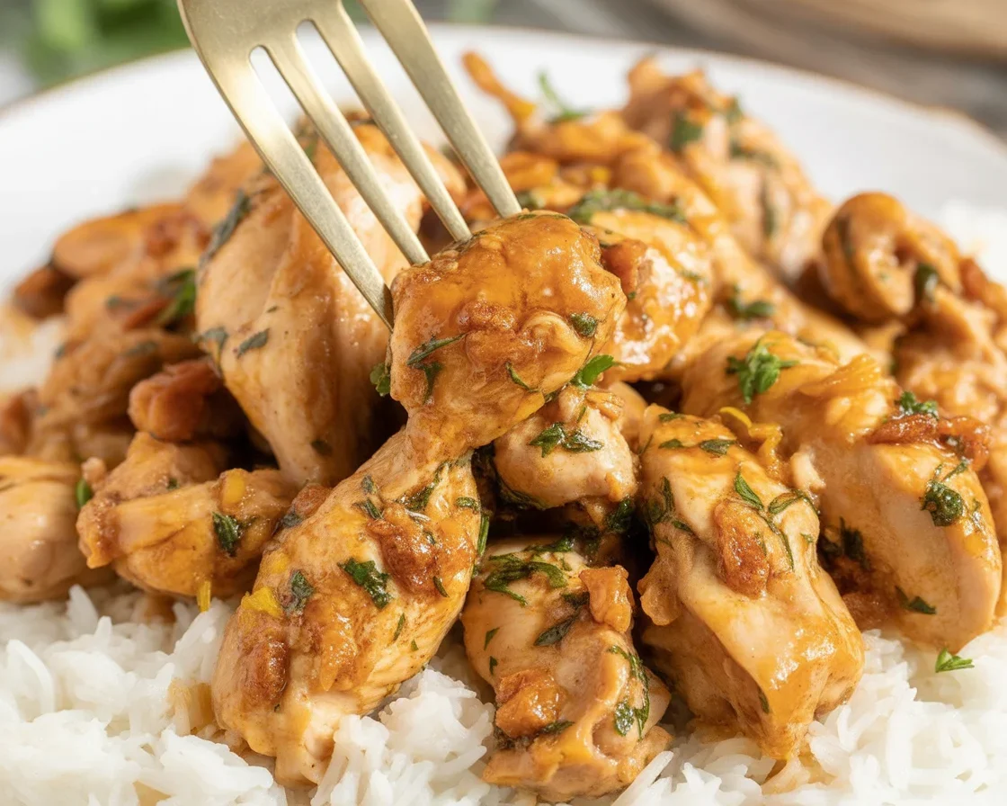 Delicious Lemon Garlic Chicken Bites served with creamy pasta on a plate.