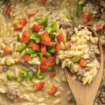 One-Pot Cheeseburger Orzo Skillet served in a deep skillet, showcasing a hearty, cheesy meal.