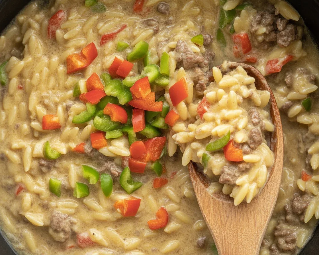 One-Pot Cheeseburger Orzo Skillet served in a deep skillet, showcasing a hearty, cheesy meal.