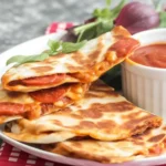 Delicious Pepperoni Pizza Quesadillas served with pizza sauce and cheese.
