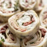 Chicken Bacon Ranch Roll Ups with cream cheese and bacon mixture wrapped in tortillas.