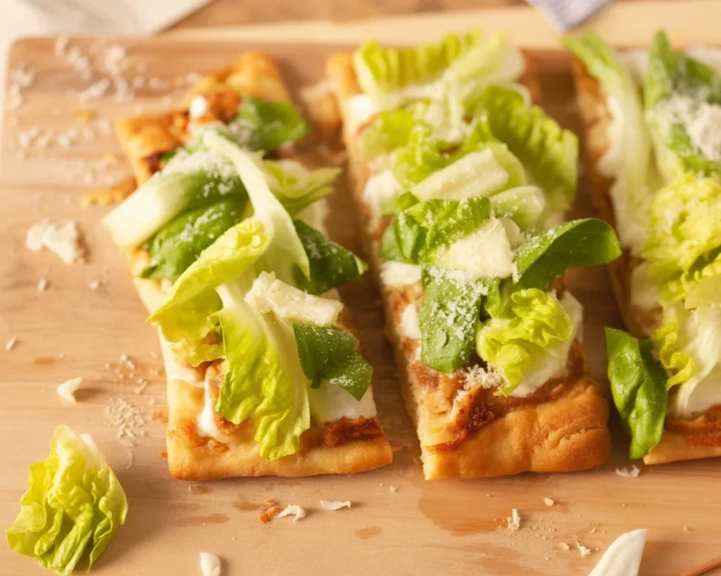 Delicious Chicken Caesar Flatbread topped with grilled chicken and Caesar dressing.