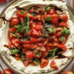 Delicious Bruschetta Dip topped with fresh tomatoes and balsamic glaze, served with toasted bread.