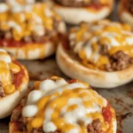 Old school pizza burgers made with ground beef, pizza sauce, and cheddar cheese.
