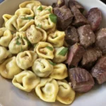 Delicious Garlic Butter Steak Bites served with Creamy Pesto Alfredo Tortellini