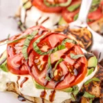 Delicious Grilled California Avocado Chicken topped with fresh mozzarella and tomatoes