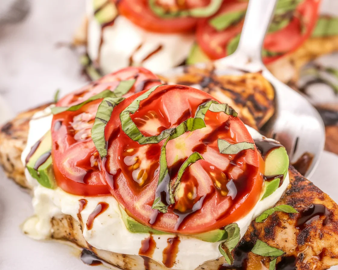 Delicious Grilled California Avocado Chicken topped with fresh mozzarella and tomatoes