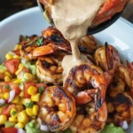 Delicious Grilled Shrimp Bowl with Avocado, Corn Salsa, and Creamy Garlic Sauce.