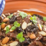 Traditional Moroccan beef and prune tagine served with spices and aromatic flavors.