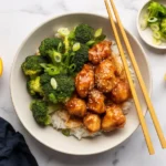 Crispy Orange Chicken with Tangy Citrus Glaze served on a plate with garnish