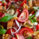 Classic Italian Panzanella Salad with tomatoes, bread, cucumber, and basil.