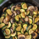 Delicious sautéed mushrooms and zucchini with butter and garlic in a skillet