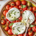 Hot Caprese Dip with Roasted Tomatoes and Burrata served with fresh basil.