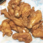 Brined chicken breast tenders soaking in saltwater for enhanced flavor and juiciness.