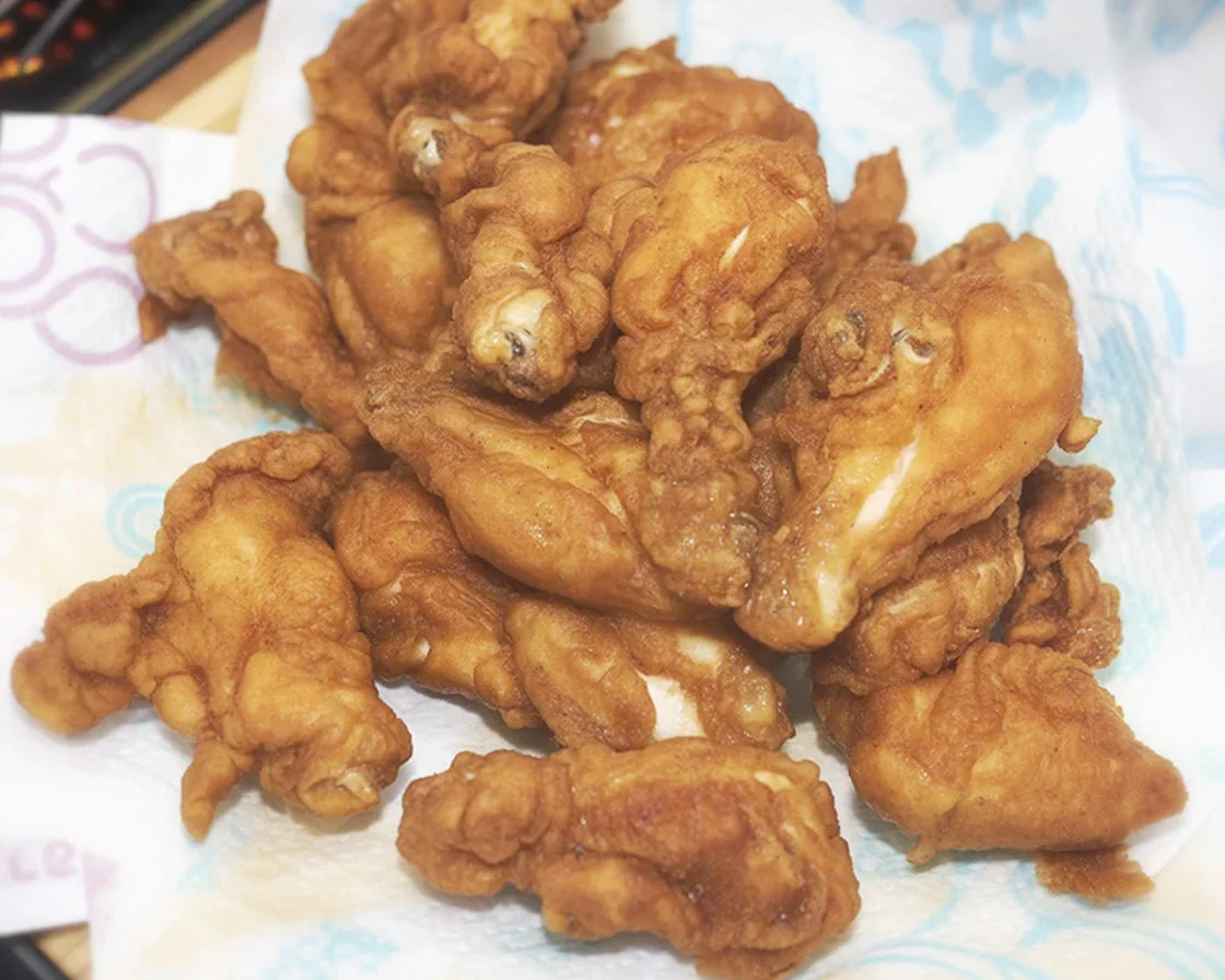 Brined chicken breast tenders soaking in saltwater for enhanced flavor and juiciness.