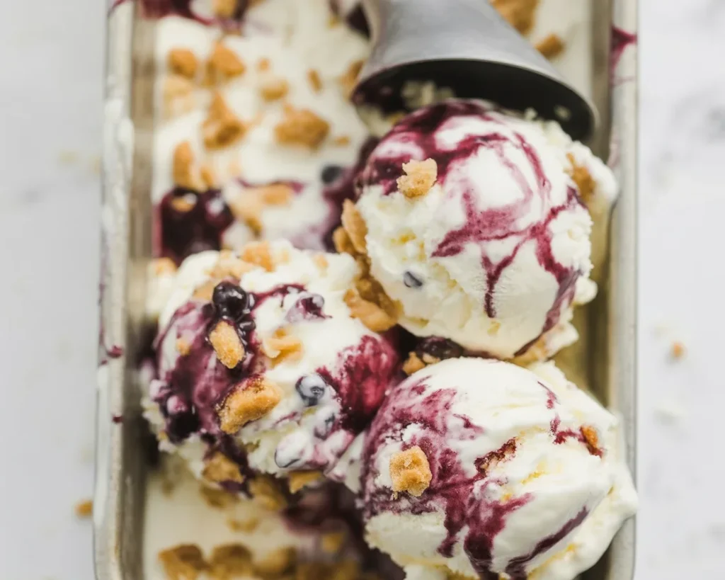 Huckleberry Vanilla Bean Ice Cream Swirl with wild huckleberries and creamy texture.