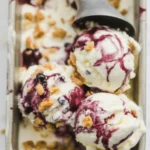 Huckleberry Vanilla Bean Ice Cream Swirl with wild huckleberries and creamy texture.