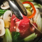 A delicious bowl of Shabu Shabu Hot Pot with fresh ingredients and broth.