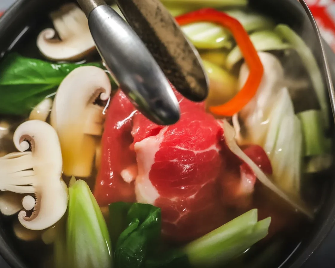 A delicious bowl of Shabu Shabu Hot Pot with fresh ingredients and broth.