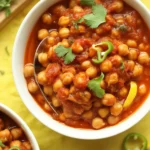 Delicious Chana Masala served with rice and garnished with cilantro and spices.