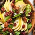 Fresh Pear and Gorgonzola Salad with candied pecans and vibrant greens.