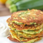 Savory zucchini and potato pancakes served with a creamy sauce.