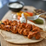 Grilled Chicken Shish Tawook Skewers served with garlic sauce and spices.
