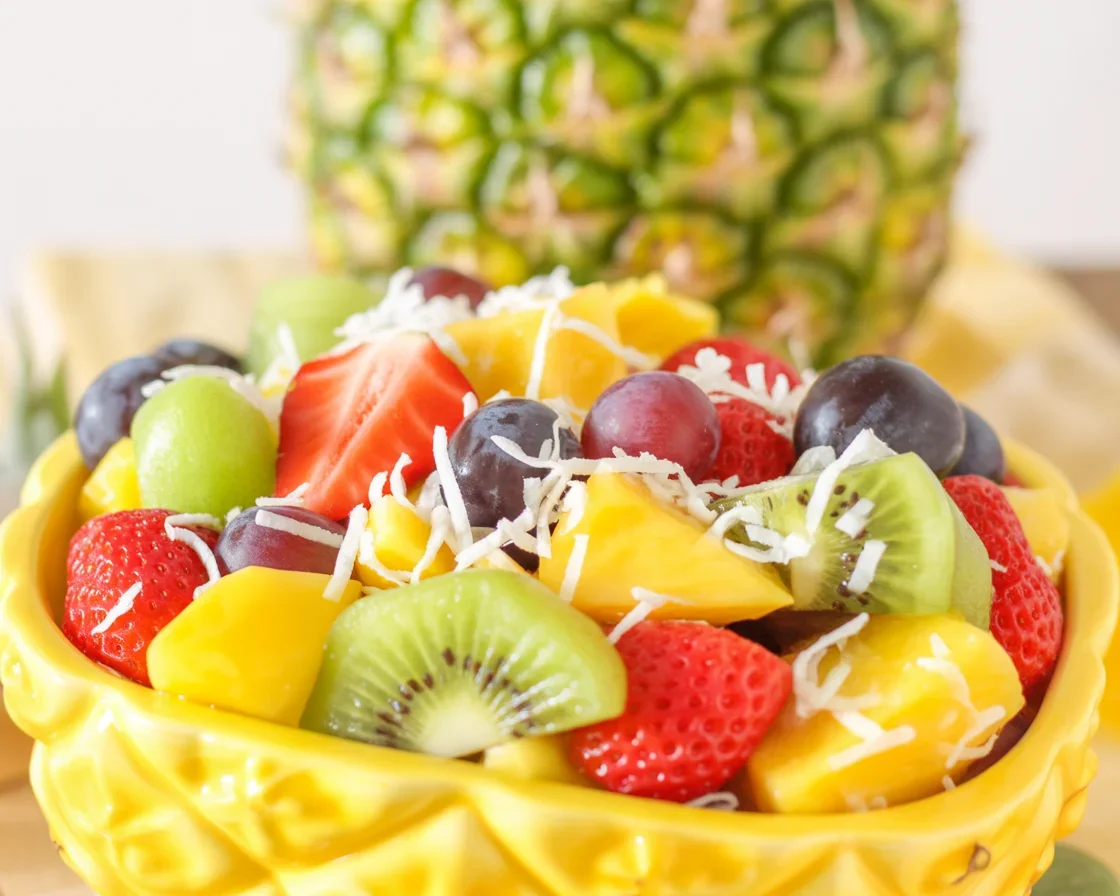 Colorful Tropical Fruit Salad with Honey-Lime Dressing in a bowl.