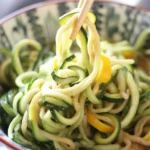 Zoodle Sesame dish with zucchini noodles, crispy tofu, and sesame sauce.